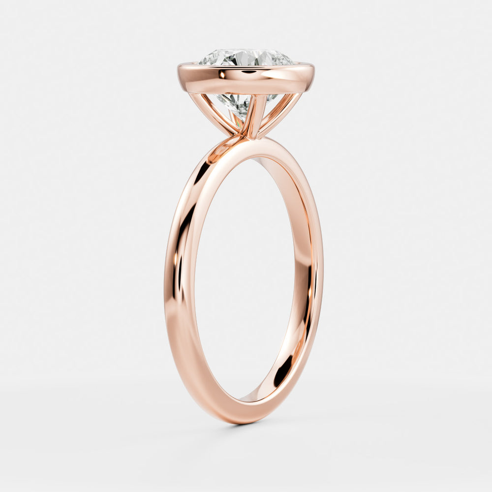 
                      
                        The Isla Ring - Round Bezel Solitaire
                      
                    