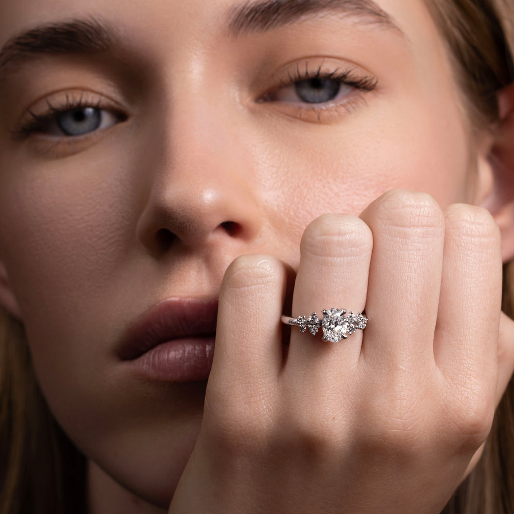 
                      
                        The Aurora Ring - Oval with Round Brilliant Accents
                      
                    