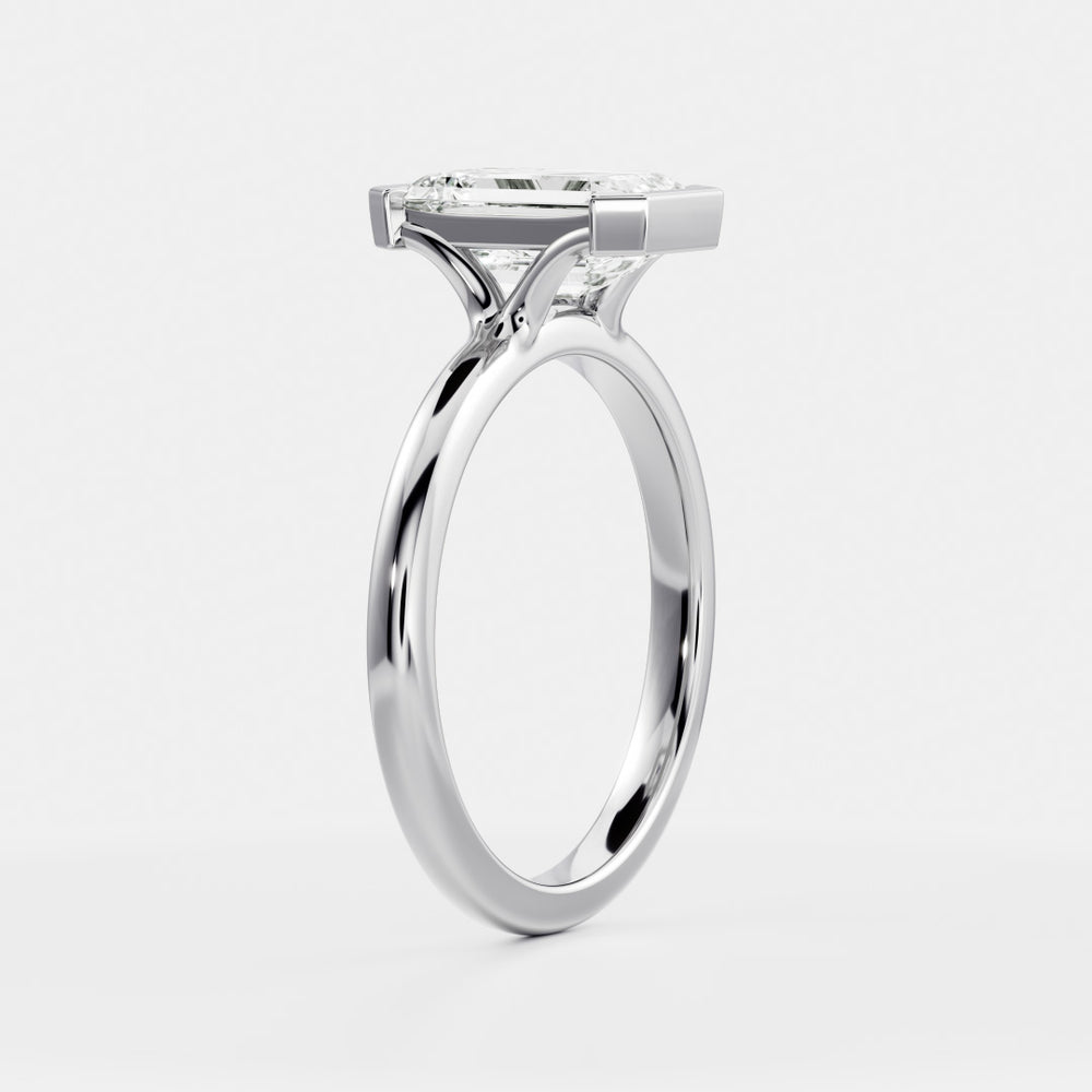 
                      
                        The Audrey Ring - Emerald Half Bezel Solitaire
                      
                    
