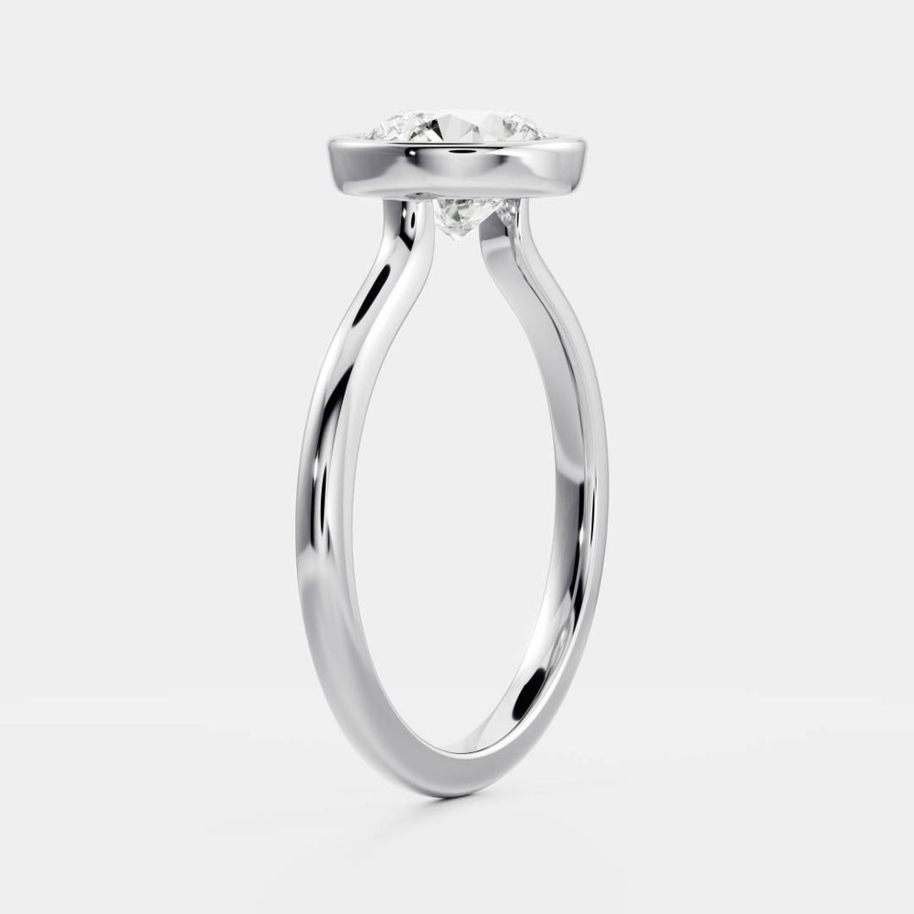 
                      
                        The Isla Ring - Round Bezel Solitaire
                      
                    