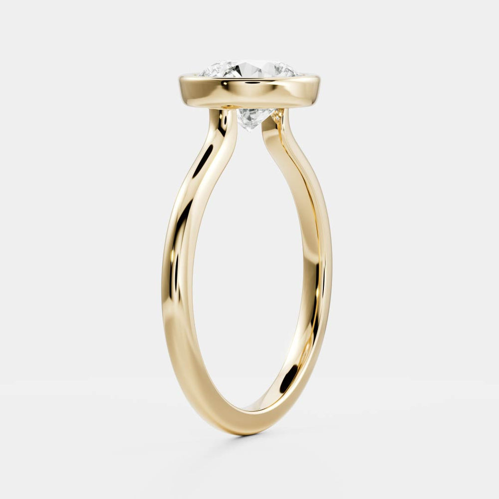
                      
                        The Isla Ring - Round Bezel Solitaire
                      
                    