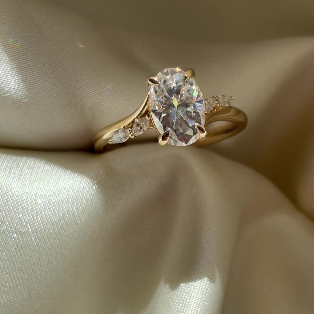 
                      
                        Load and play video in Gallery viewer, The Amira Ring - 1.8ct Moissanite Oval with Marquise Accents with Pavé Bridge
                      
                    